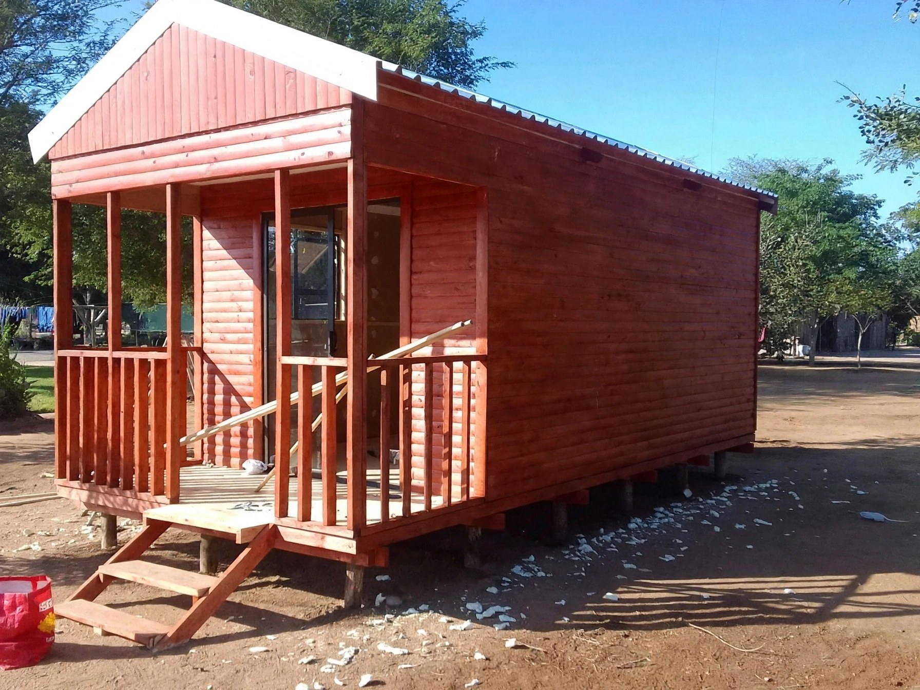 Timber cabin with covered porch and railing