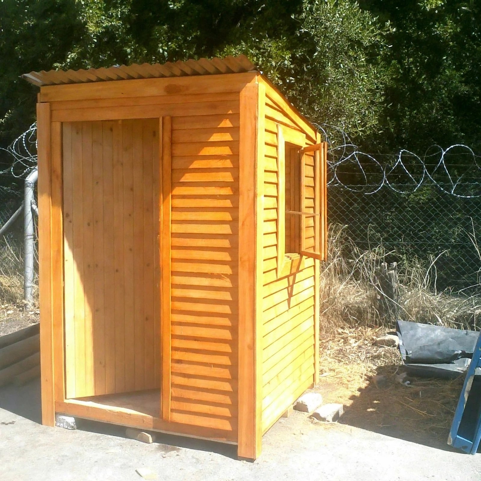 Small timber Wendy house with open doorway