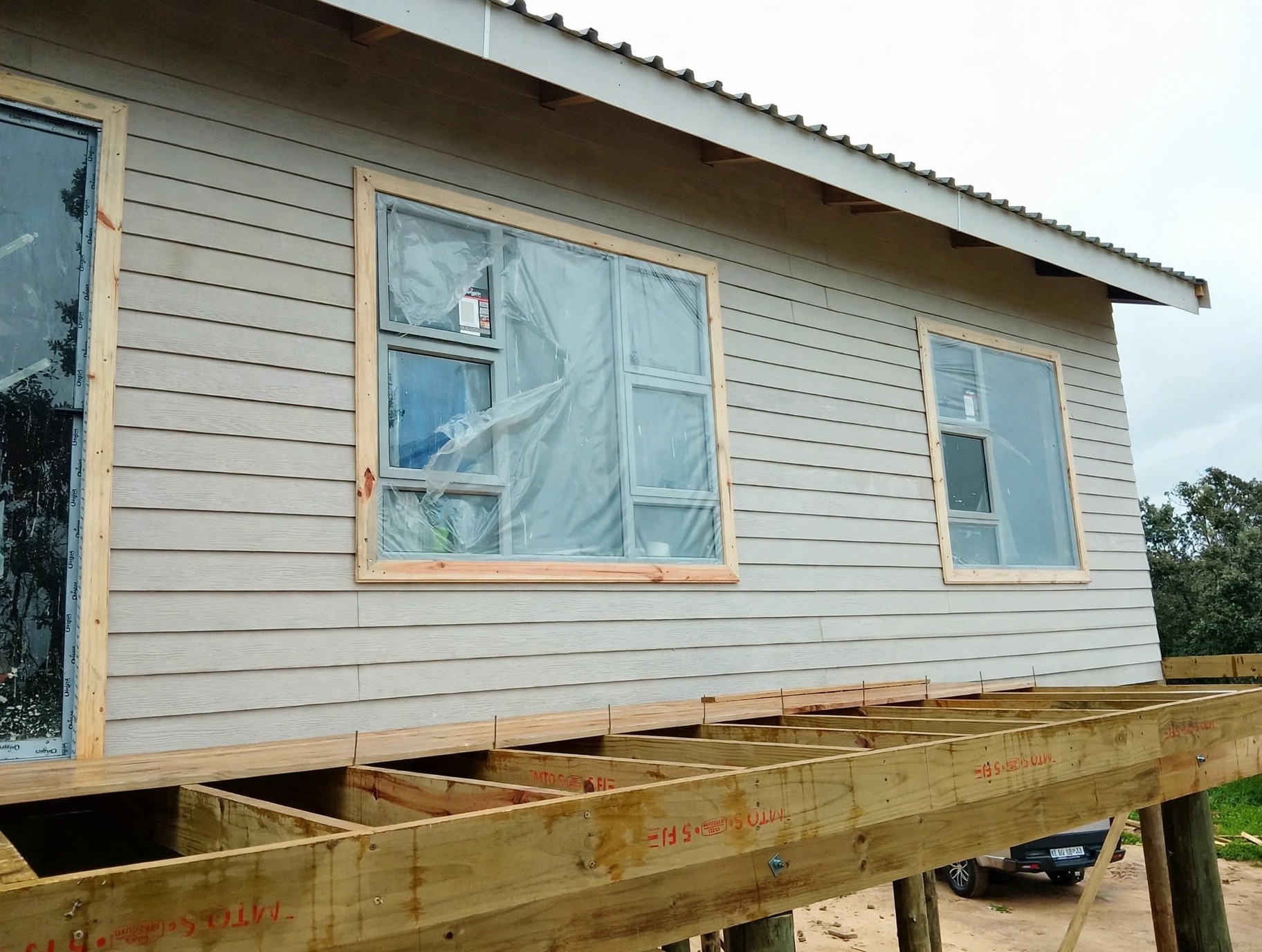 Close view of a clad home during construction
