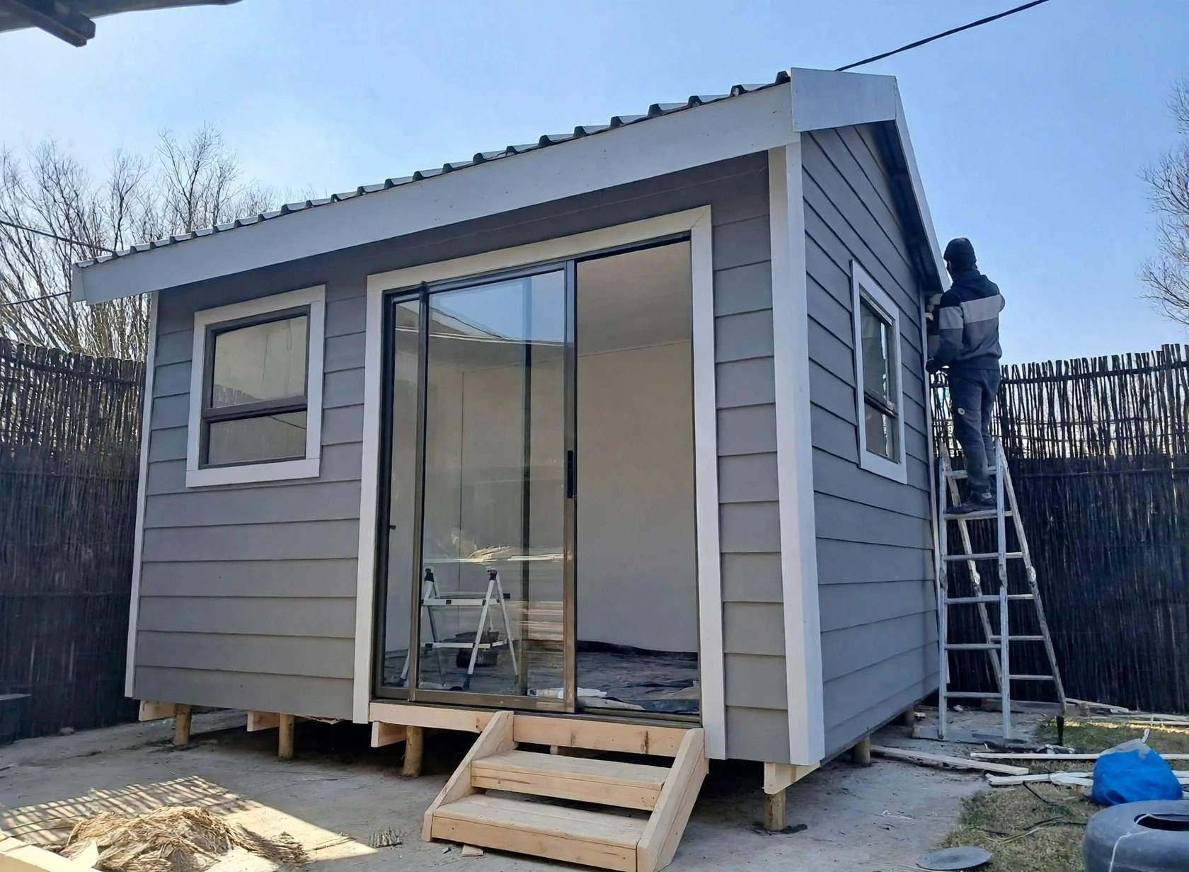 Compact grey clad home with glazed doors