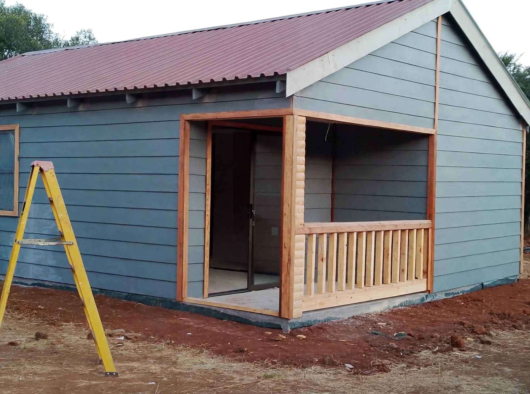 Blue-grey clad home with covered front porch