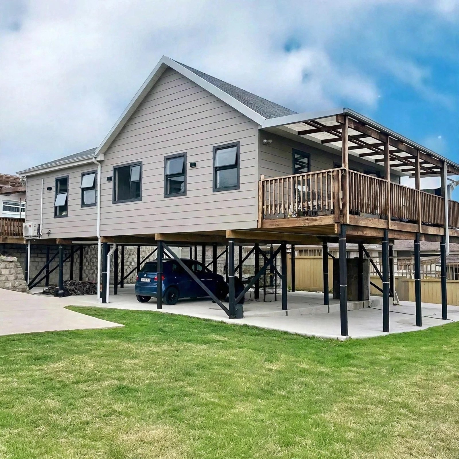 Raised light-grey home with a timber veranda