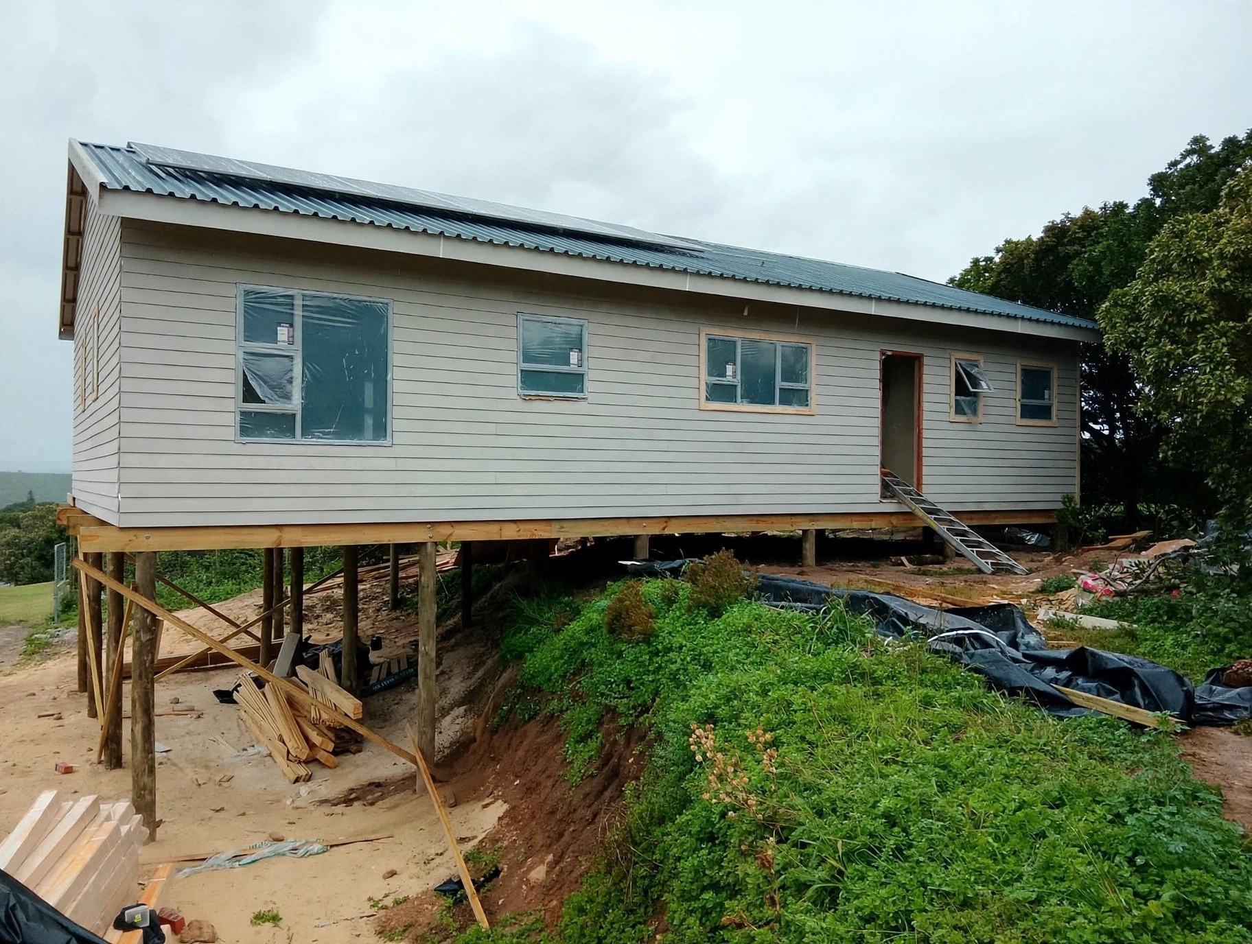 Long light-coloured home on raised foundations